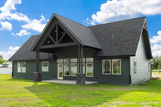 rear view of property with a patio area and a lawn