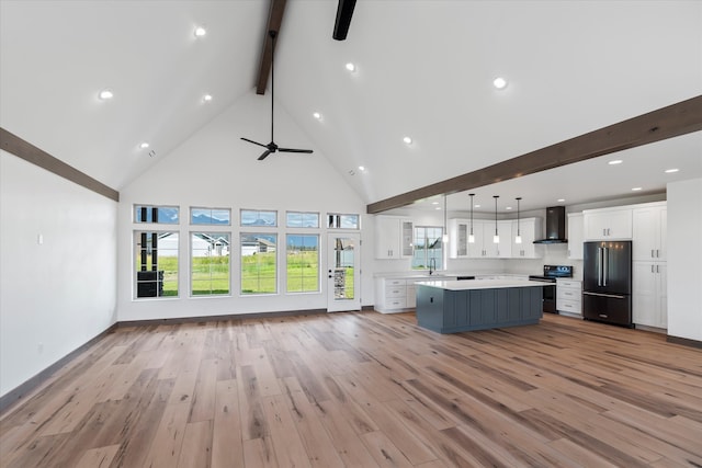 interior space featuring high vaulted ceiling, ceiling fan, beamed ceiling, and light wood-type flooring