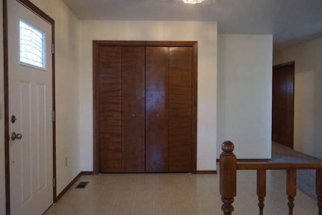 foyer featuring light tile floors
