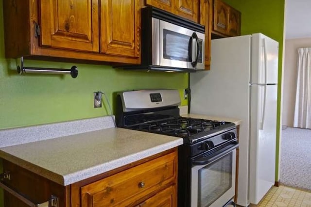 kitchen with light tile floors and range with gas cooktop