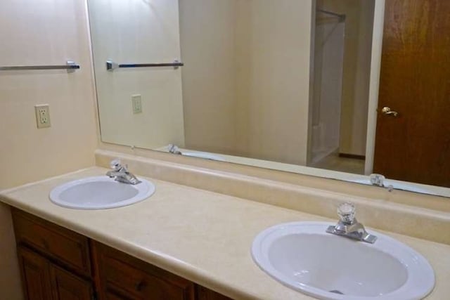 bathroom with large vanity and dual sinks