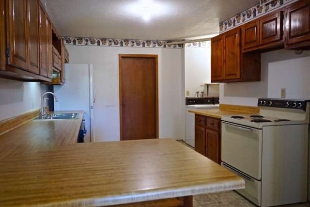 kitchen with sink and electric range