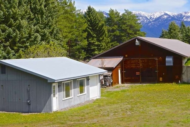 exterior space with a yard and a mountain view