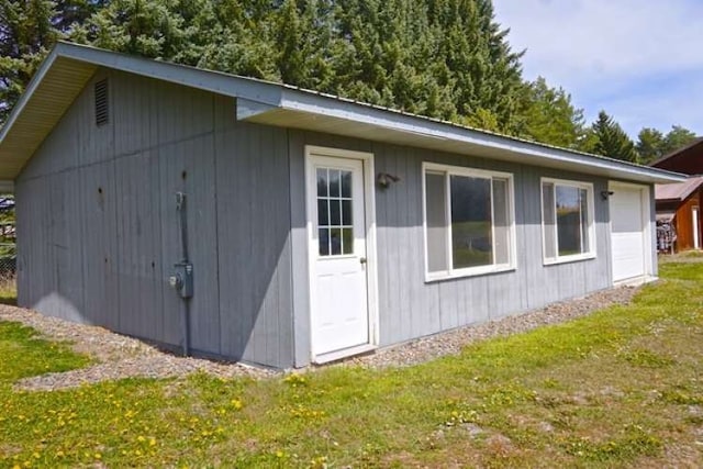 view of outdoor structure featuring a lawn