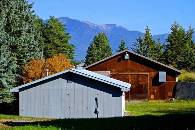 exterior space with a mountain view and a yard