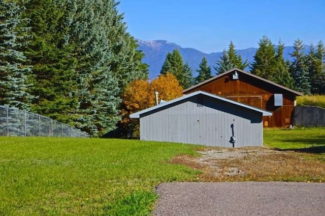 exterior space featuring a mountain view and a lawn