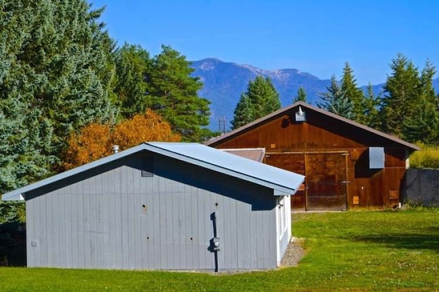 view of shed / structure featuring a mountain view and a yard