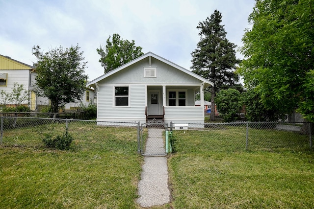 bungalow featuring a front lawn and a porch