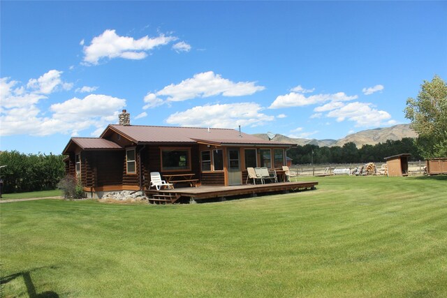 240 Ponderosa Rd, Melrose, MT 59743 - rear view of property featuring a lawn, metal roof, a chimney, log exterior, and a deck with mountain view