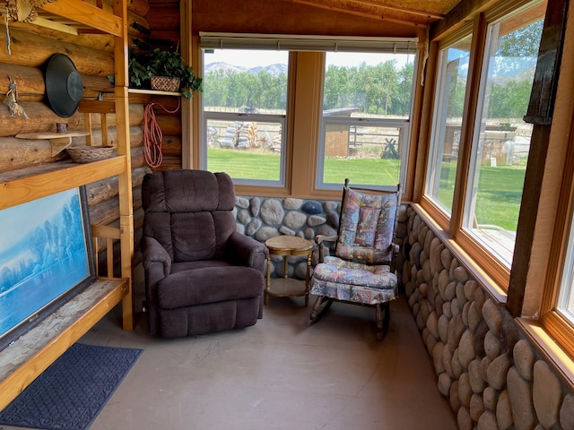 240 Ponderosa Rd, Melrose, MT 59743 - sunroom featuring log walls, concrete flooring, and vaulted ceiling