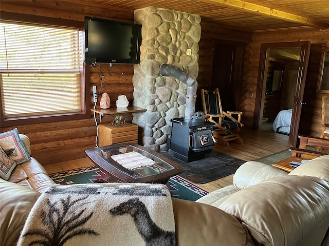 240 Ponderosa Rd, Melrose, MT 59743 - living area with wooden ceiling, a wood stove, hardwood / wood-style flooring, and rustic walls