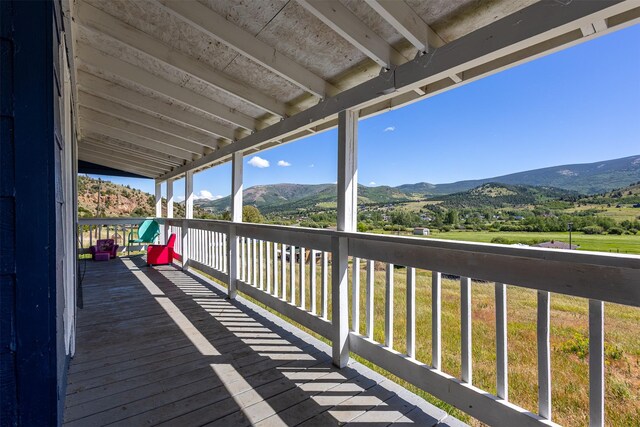 wooden deck with a mountain view