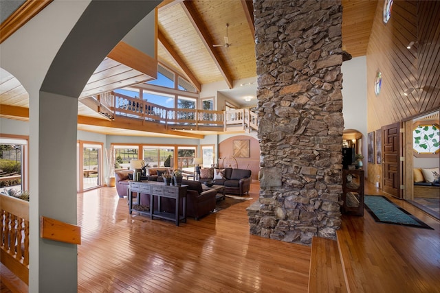 417 Sirucek Ln, Kalispell, MT 59901 - living area with high vaulted ceiling, arched walkways, hardwood / wood-style flooring, and a wooden ceiling with exposed beams