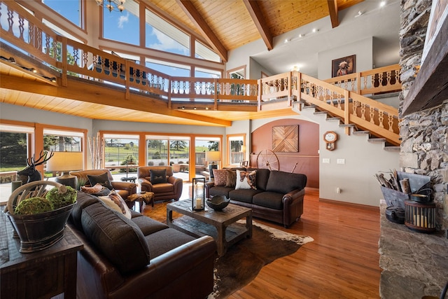417 Sirucek Ln, Kalispell, MT 59901 - living area featuring a wood ceiling with exposed beams, high vaulted ceiling, wood finished floors, and stairs