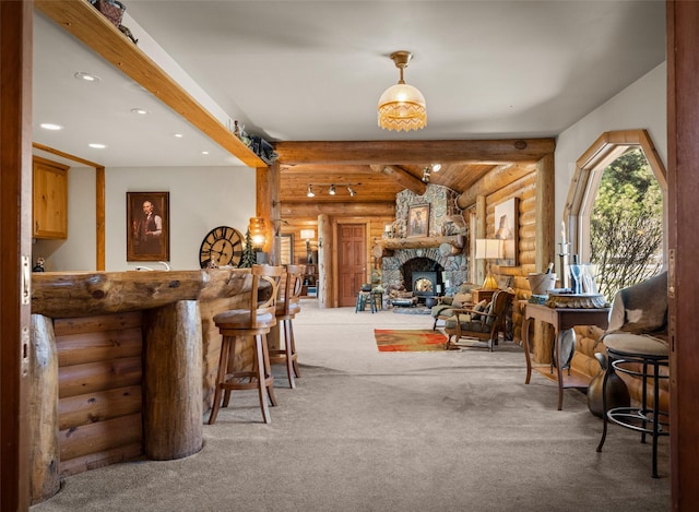 417 Sirucek Ln, Kalispell, MT 59901 - bar area featuring log walls, beamed ceiling, carpet, recessed lighting, and a stone fireplace