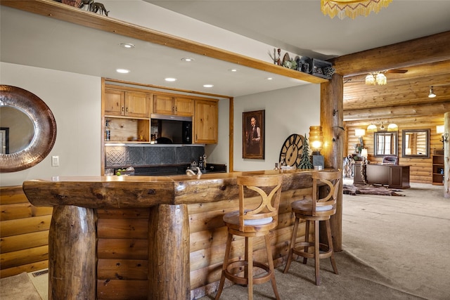 417 Sirucek Ln, Kalispell, MT 59901 - indoor wet bar with black microwave, rustic walls, recessed lighting, light carpet, and beam ceiling