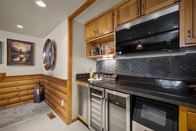 417 Sirucek Ln, Kalispell, MT 59901 - indoor bar with stainless steel microwave, rustic walls, beverage cooler, backsplash, and recessed lighting
