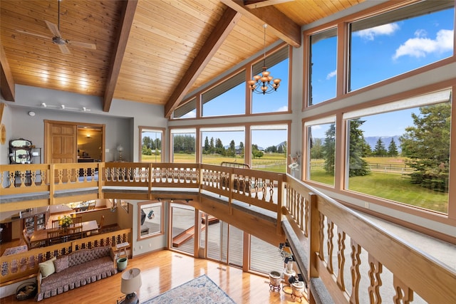 sunroom / solarium featuring vaulted ceiling with beams, wood ceiling, and a chandelier