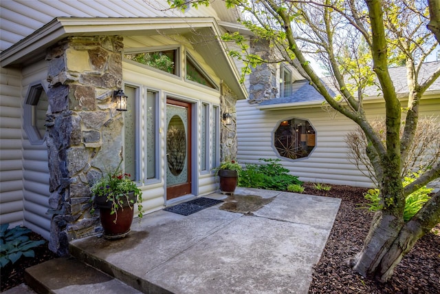 417 Sirucek Ln, Kalispell, MT 59901 - doorway to property with stone siding, a patio, and log veneer siding