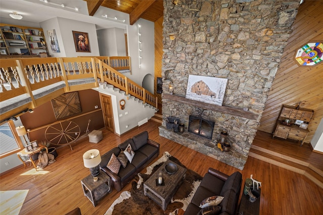 417 Sirucek Ln, Kalispell, MT 59901 - living area with wood finished floors, a fireplace, beamed ceiling, and stairs