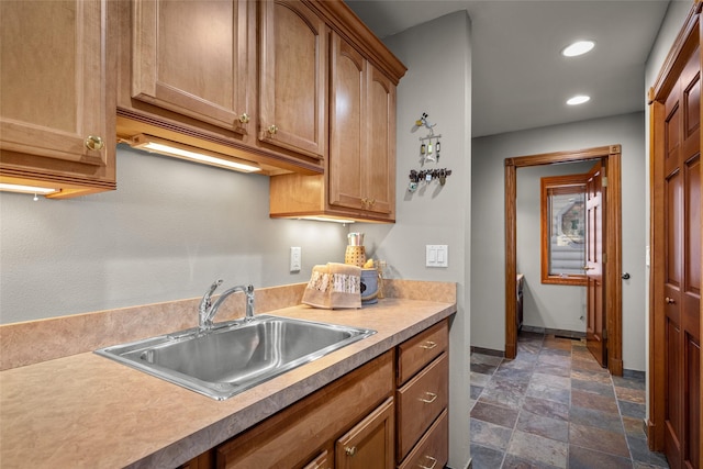 417 Sirucek Ln, Kalispell, MT 59901 - kitchen with stone finish floors, recessed lighting, light countertops, and brown cabinets