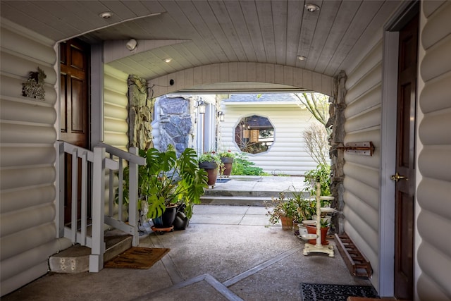 417 Sirucek Ln, Kalispell, MT 59901 - view of exterior entry featuring covered porch and log veneer siding