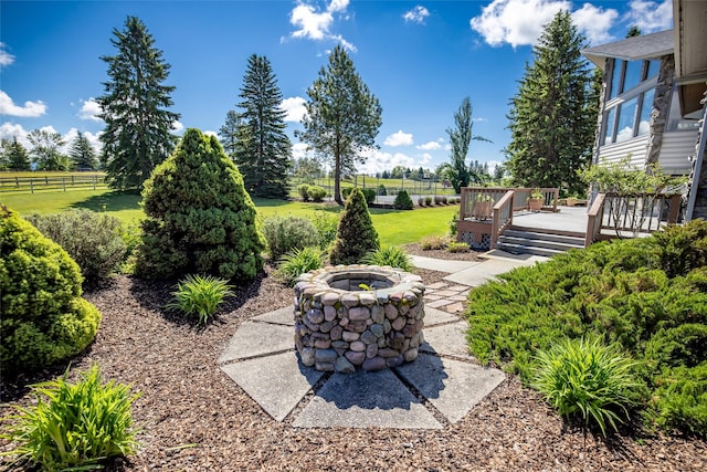 417 Sirucek Ln, Kalispell, MT 59901 - view of patio / terrace with a fire pit, a deck, and a view of countryside