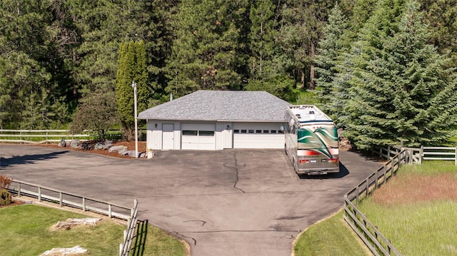 417 Sirucek Ln, Kalispell, MT 59901 - detached garage featuring driveway and a wooded view