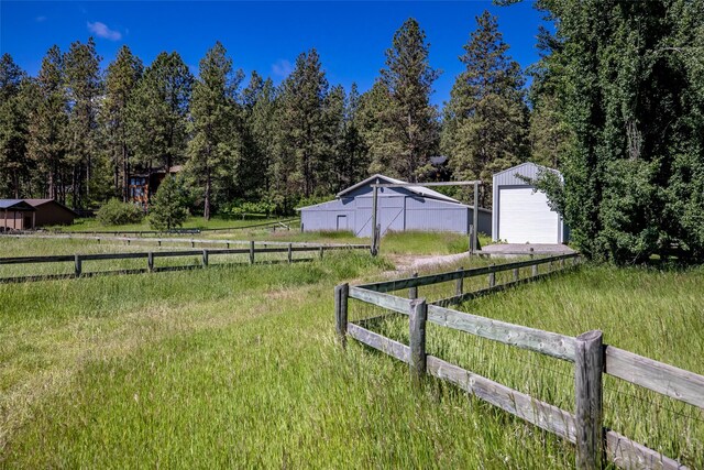 417 Sirucek Ln, Kalispell, MT 59901 - view of yard with an outdoor structure, a detached garage, and driveway