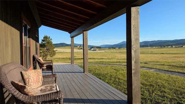 285 N Hill Rd, Kalispell, MT 59901 - deck with a rural view, a mountain view, and a lawn