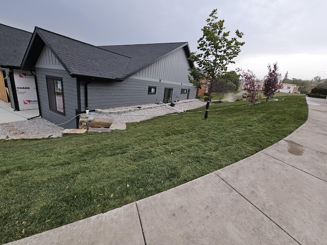 view of side of home featuring a lawn