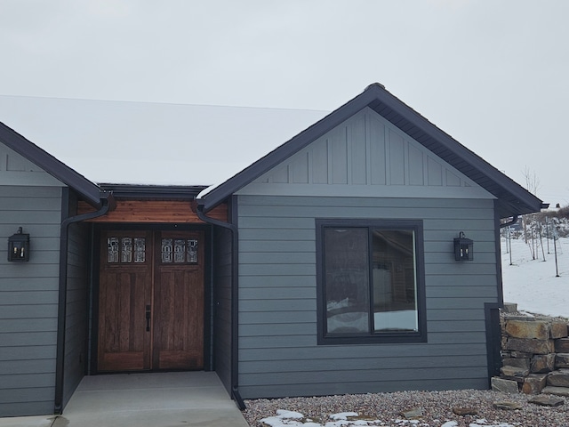 view of snow covered property entrance