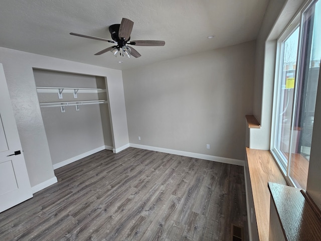 unfurnished bedroom featuring hardwood / wood-style flooring, ceiling fan, and a closet