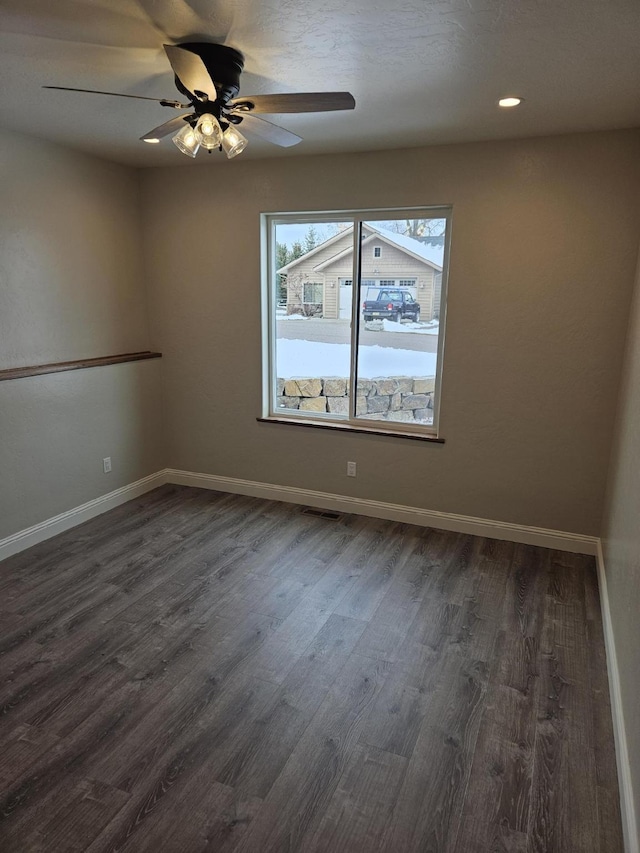 empty room featuring ceiling fan and dark hardwood / wood-style floors