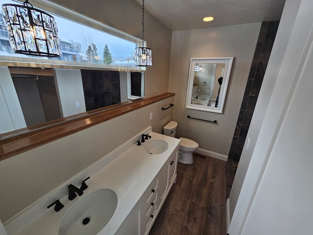 bathroom featuring hardwood / wood-style floors, vanity, a notable chandelier, toilet, and a textured ceiling