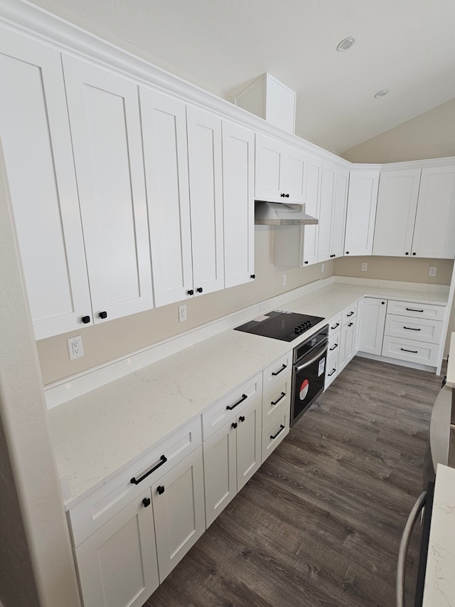 kitchen with white cabinetry, lofted ceiling, black electric stovetop, and light stone counters