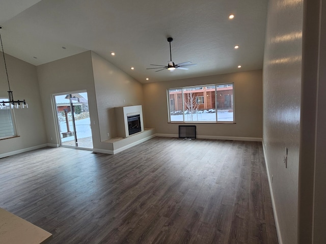 unfurnished living room with lofted ceiling, dark wood-type flooring, and ceiling fan