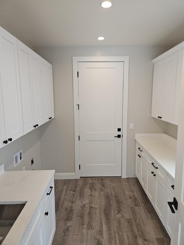 laundry area featuring sink, cabinets, washer hookup, dark hardwood / wood-style flooring, and hookup for an electric dryer