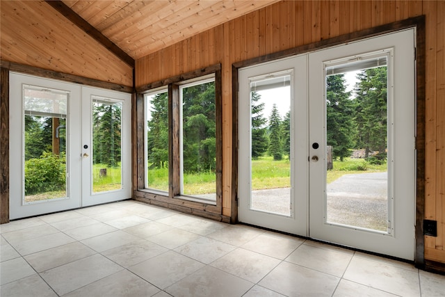 entryway featuring lofted ceiling, french doors, light tile patterned floors, wood ceiling, and plenty of natural light