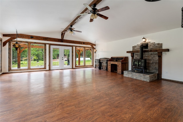 unfurnished living room with a wood stove, dark hardwood / wood-style flooring, ceiling fan, and vaulted ceiling with beams