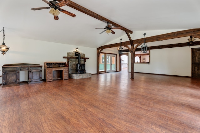 unfurnished living room with lofted ceiling with beams, dark hardwood / wood-style floors, ceiling fan, and a wood stove