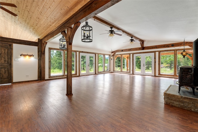 unfurnished living room with dark hardwood / wood-style flooring, french doors, plenty of natural light, and vaulted ceiling with beams