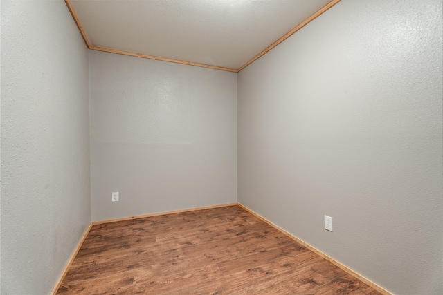 unfurnished room featuring hardwood / wood-style flooring and ornamental molding