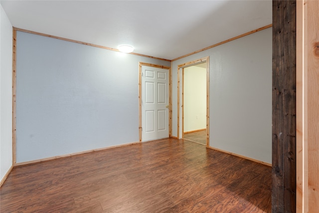 spare room with wood-type flooring and ornamental molding