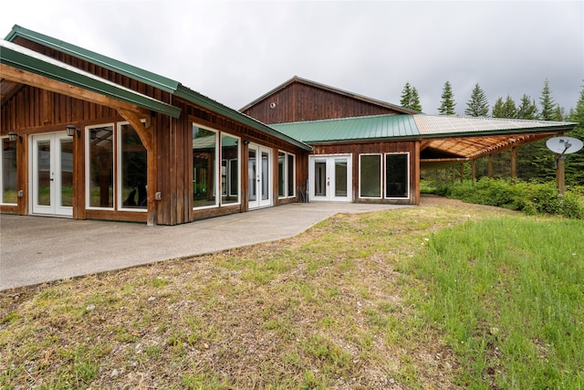 rear view of house with a patio, french doors, and a yard