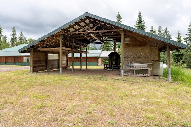 view of community with an outdoor structure and a lawn