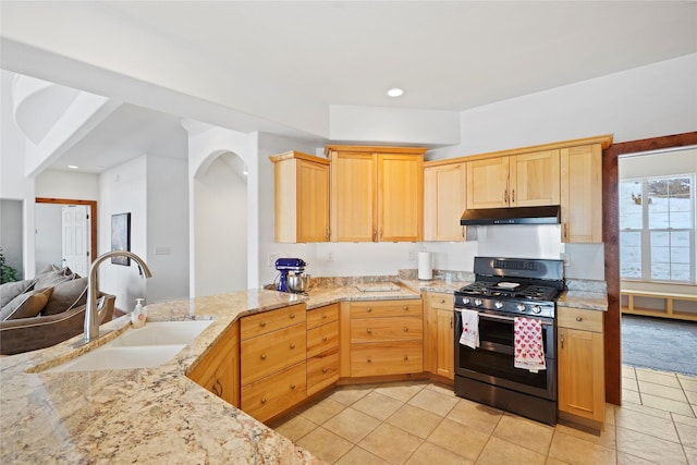 kitchen with range with gas cooktop, sink, light tile patterned floors, light stone countertops, and light brown cabinets