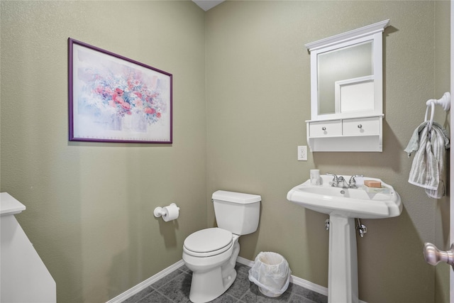 bathroom with tile patterned flooring, sink, and toilet