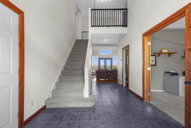 tiled entrance foyer with a high ceiling