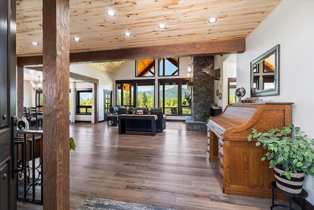 interior space with lofted ceiling with beams, an inviting chandelier, wooden ceiling, dark wood-type flooring, and decorative columns